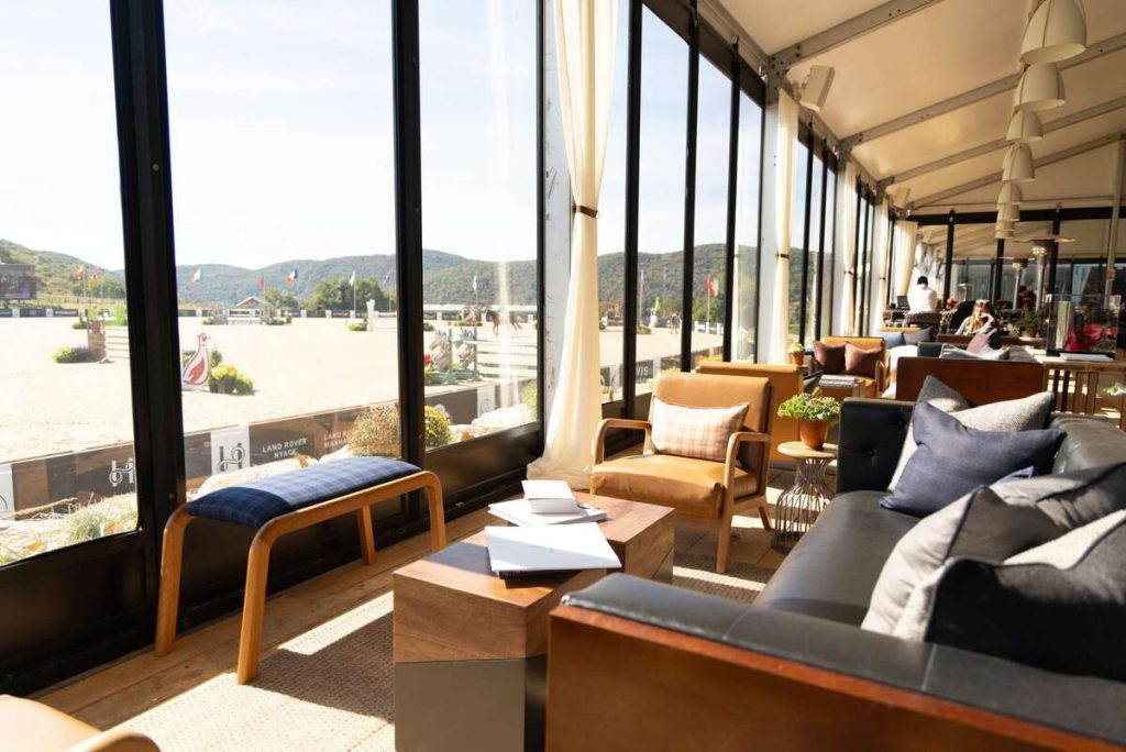 Comfortable seating by large windows overlooking stadium ring.